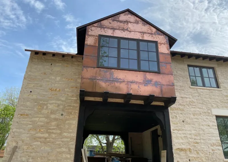 Copper metal panel facade on a stone building for Skylight Installation in Middleton